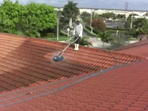 Technician performing chemical soft wash on tile roof — Smart Shield | The Roof Store Technician performing chemical soft wash on tile roof