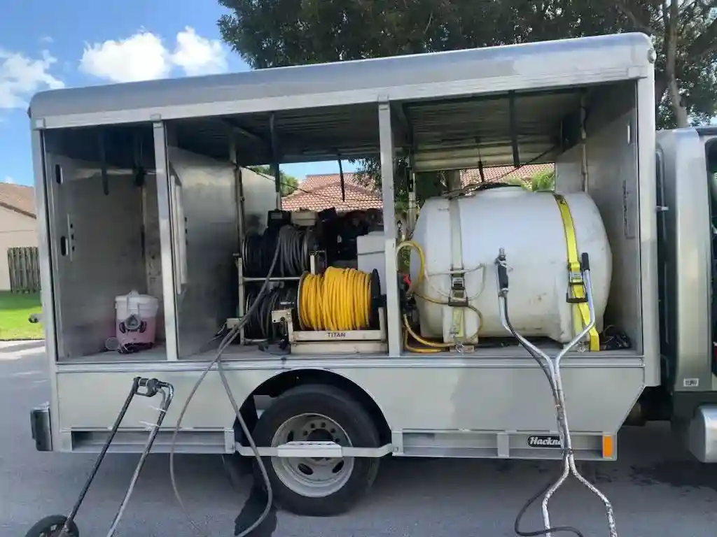 Soft wash truck and pressure cleaning equipment on Florida roofing job — Smart Shield | The Roof Store Soft wash truck and pressure cleaning equipment on Florida roofing job