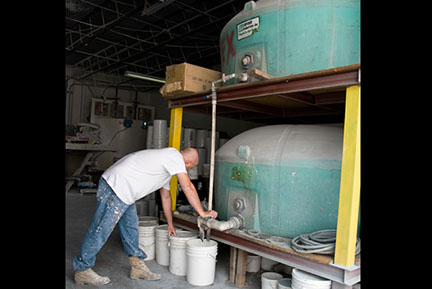 Filling 5-gallon pails from roof coating batch tanks at The Roof Store factory — Davie, Florida