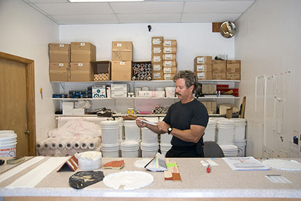 Roof coating supply counter with pails and materials at The Roof Store — Davie, FL factory