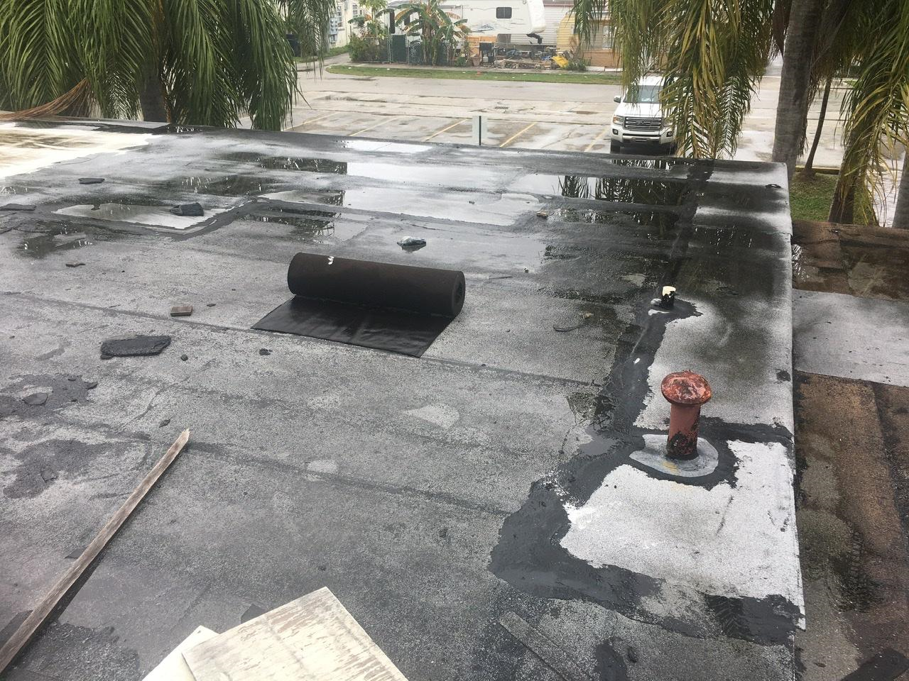 Flat roof inspection — ponding water zones, rework areas, and AC penetrations documented during manufacturer's report