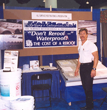 The Roof Store's founder at the company booth, Fort Lauderdale Home Show 1998–1999, with the banner Don't Reroof — Waterproof at half the cost of a reroof