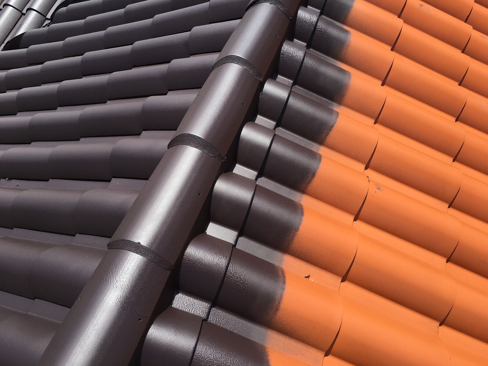 Spanish tile roof coated in Bonito Black dark color with Smart Shield cool-pigment elastomeric coating in South Florida — photo 1