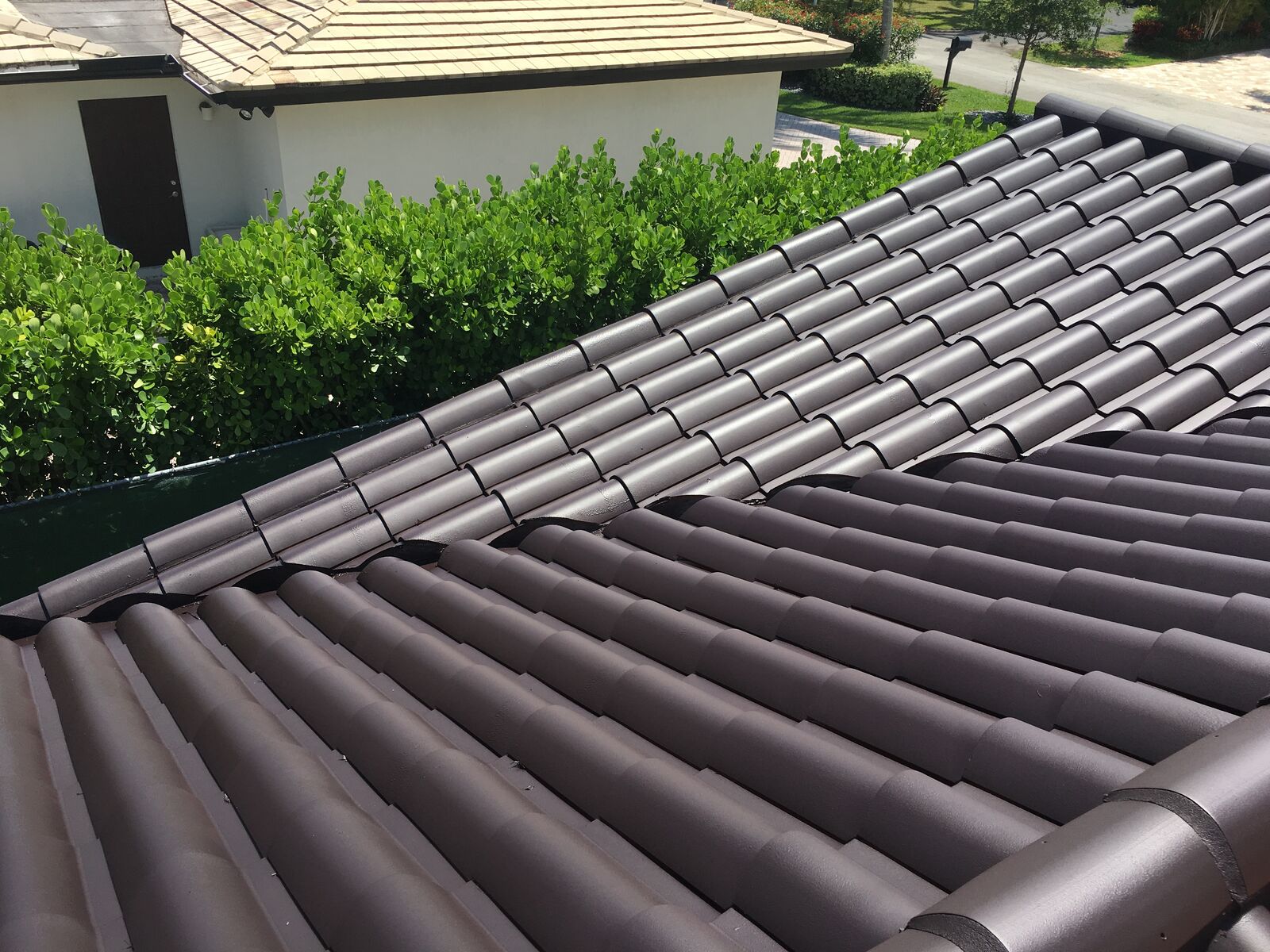 Spanish tile roof coated in Bonito Black dark color with Smart Shield cool-pigment elastomeric coating in South Florida — photo 2