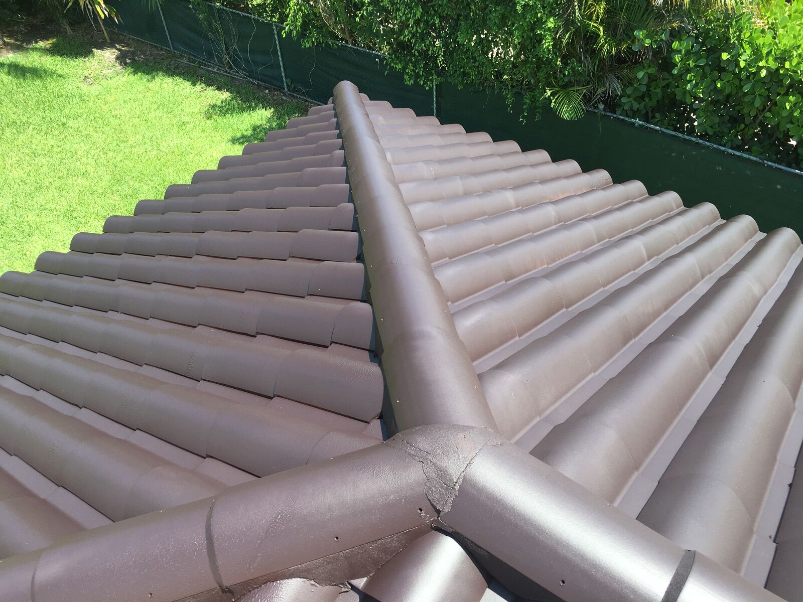 Spanish tile roof coated in Bonito Black dark color with Smart Shield cool-pigment elastomeric coating in South Florida — photo 3